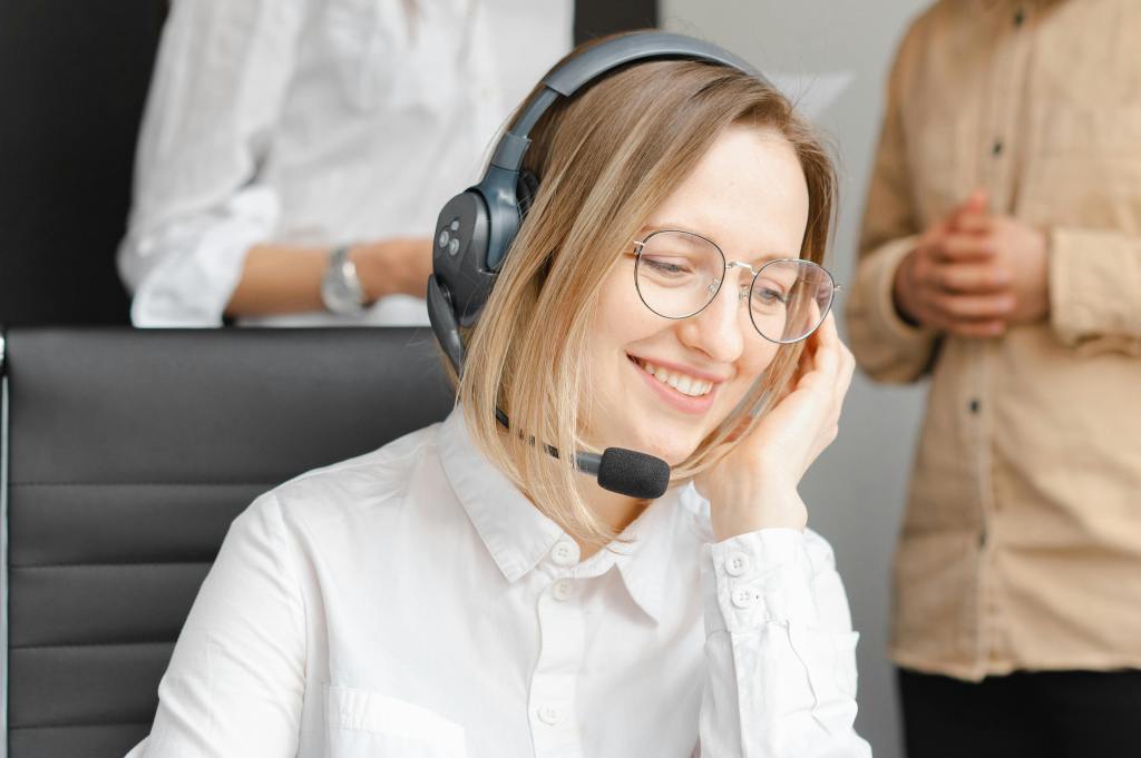 Woman smiling with headphones in a relaxed working position